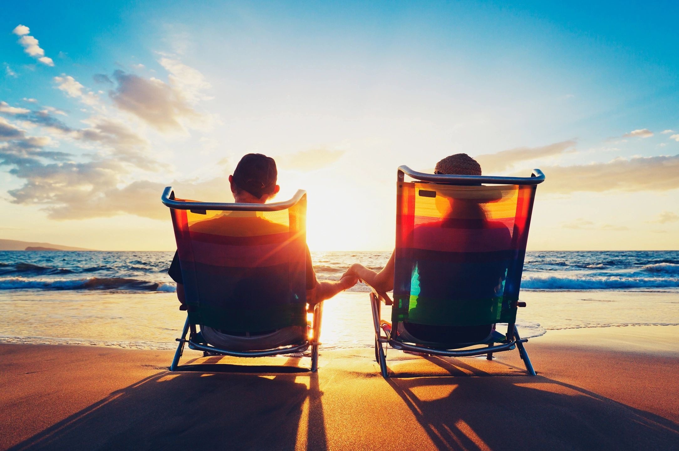 67b37ce35de11_fmf_91489 Two people sitting in lawn chairs on the beach