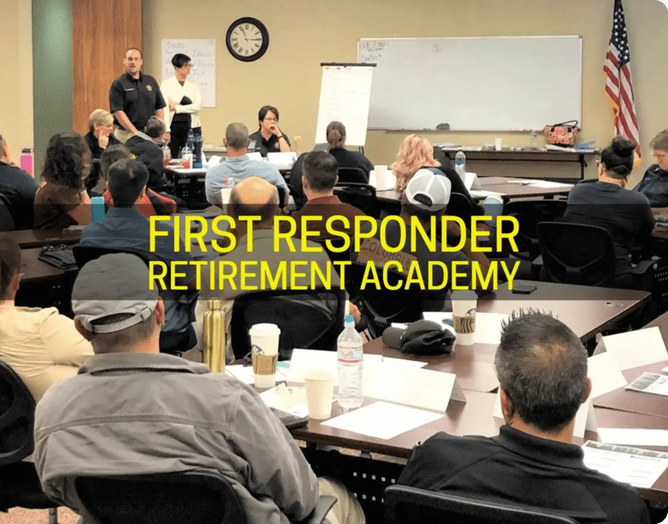 A group of people sitting in front of a whiteboard.